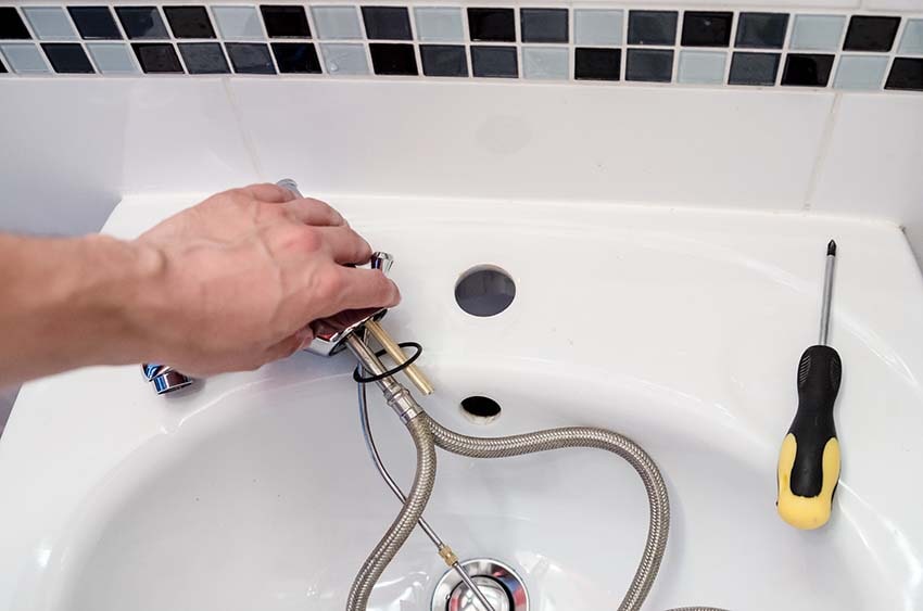 plumber fixing faucet
